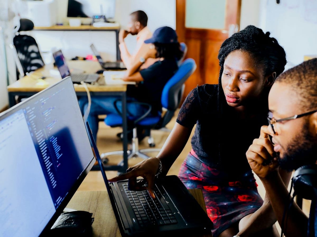 Professionals collaborating and mentoring in a community business workspace